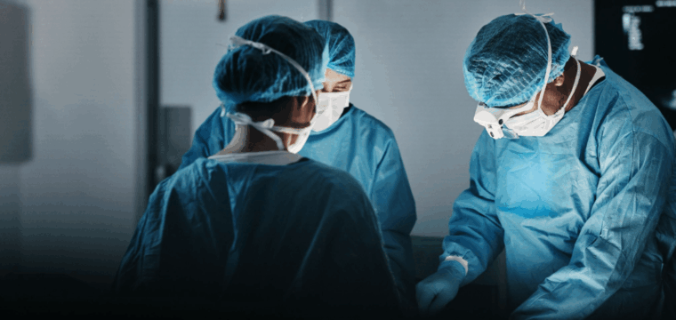 Surgical team performing an operation in a hospital theatre, illustrating that surgery is one treatment option for Peyronie’s disease in selected cases.