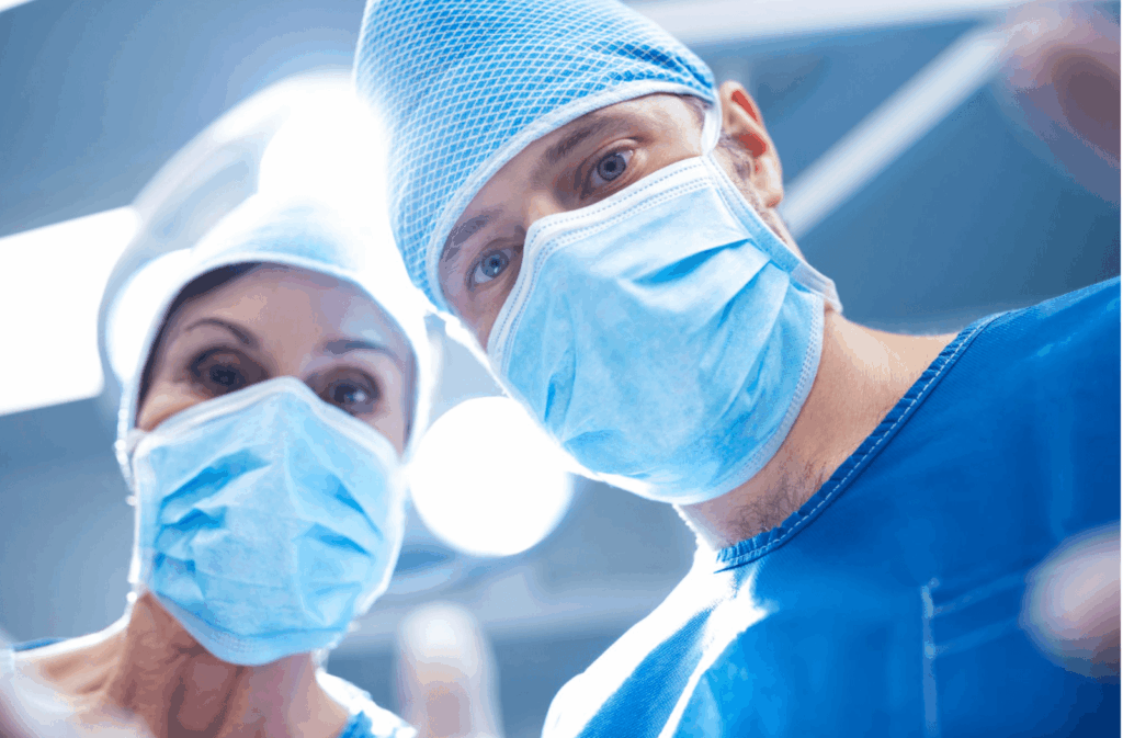 Surgeons looking down during a procedure, representing the careful planning and specialist assessment involved in Peyronie’s disease surgery.